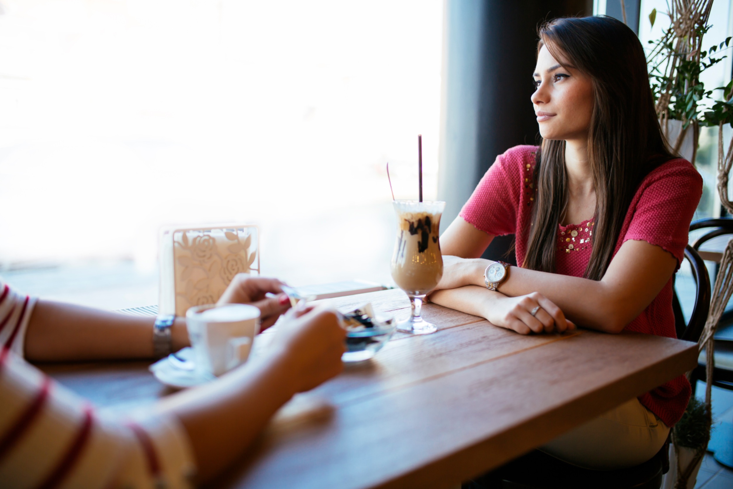 Woman Talking to a Friend in a Restaurant