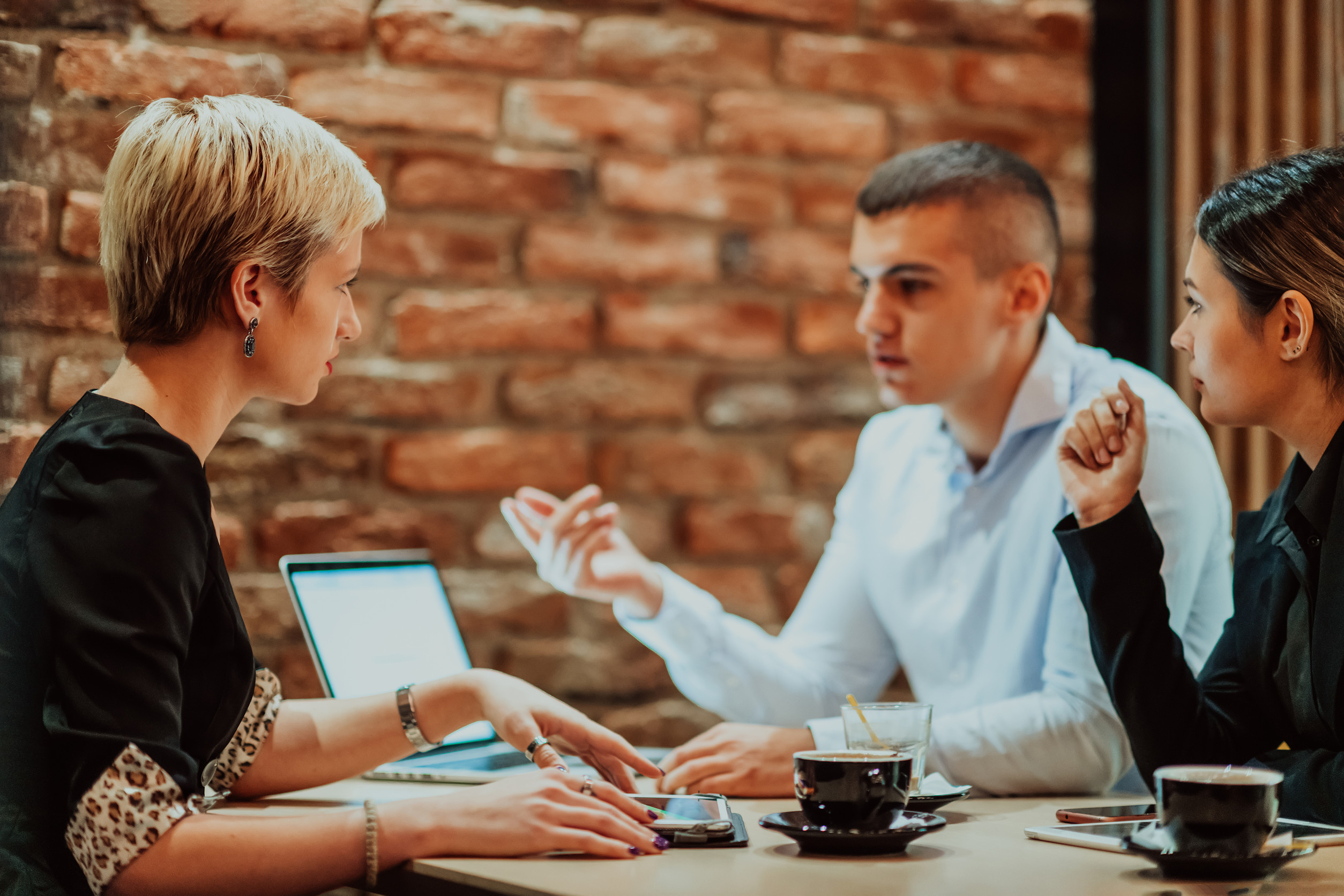 Business People Discussing Project in a Cafe